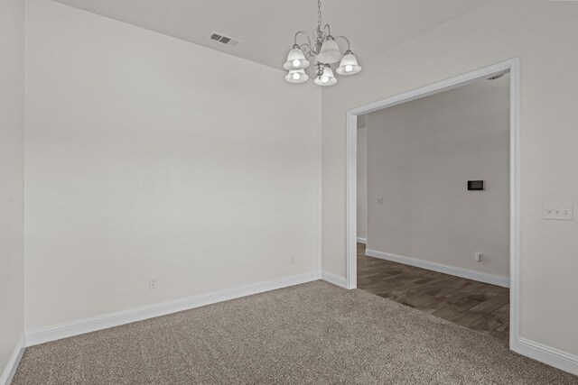 1306 Randolph Ln, Midland, TX 79705 - unfurnished room featuring carpet floors, a chandelier, and baseboards
