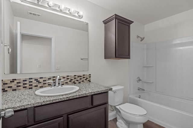 1306 Randolph Ln, Midland, TX 79705 - bathroom featuring vanity, backsplash, toilet, shower / tub combination, and wood finished floors