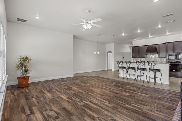 1306 Randolph Ln, Midland, TX 79705 - living area with dark wood finished floors, a ceiling fan, recessed lighting, baseboards, and arched walkways