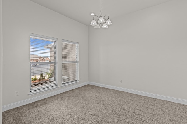 1306 Randolph Ln, Midland, TX 79705 - carpeted empty room with a chandelier and baseboards