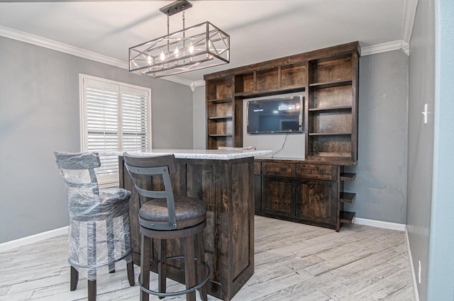 bar featuring dark brown cabinetry, light wood-type flooring, and ornamental molding