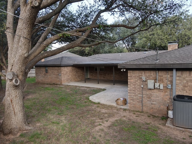 view of yard with central AC unit and a patio area