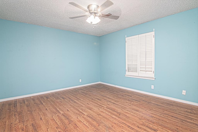 unfurnished room with a textured ceiling, hardwood / wood-style flooring, and ceiling fan