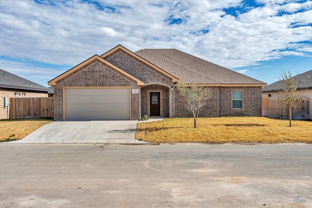 view of front of property featuring a front yard and a garage