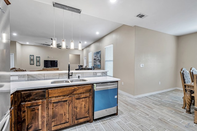 kitchen featuring sink, stainless steel dishwasher, ceiling fan, decorative light fixtures, and light hardwood / wood-style floors