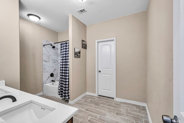 bathroom featuring hardwood / wood-style floors, vanity, and shower / tub combo with curtain