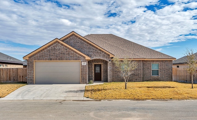 view of front of property with a front lawn and a garage