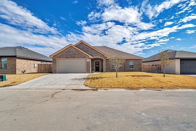 ranch-style house featuring a garage, a front yard, and central AC