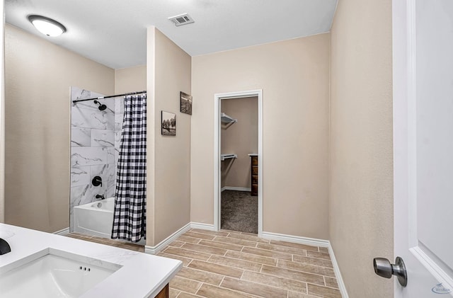 bathroom featuring vanity, hardwood / wood-style flooring, and shower / bathtub combination with curtain