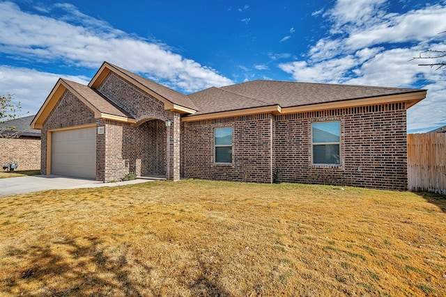 view of front of home with a garage and a front lawn