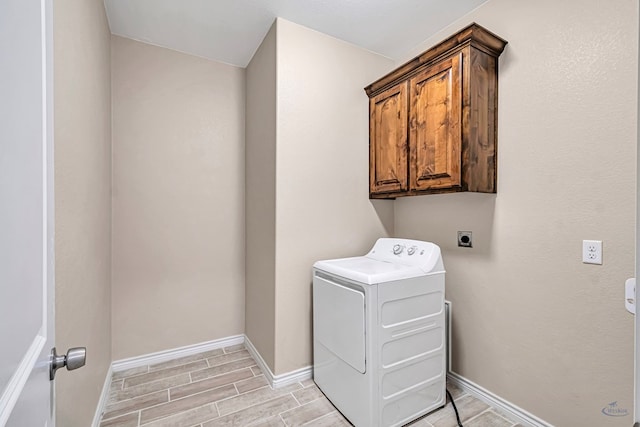 washroom featuring cabinets, washer / dryer, and light hardwood / wood-style floors