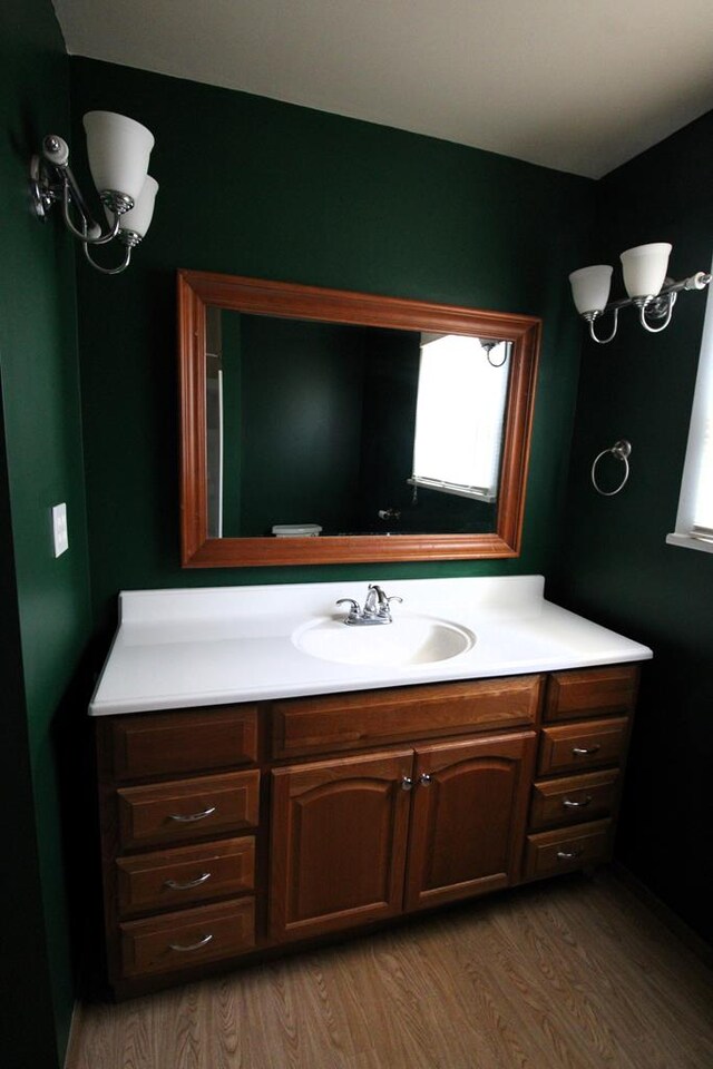 bathroom with vanity and wood-type flooring