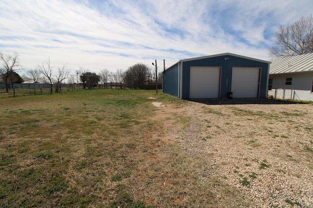 view of yard featuring a garage and an outdoor structure