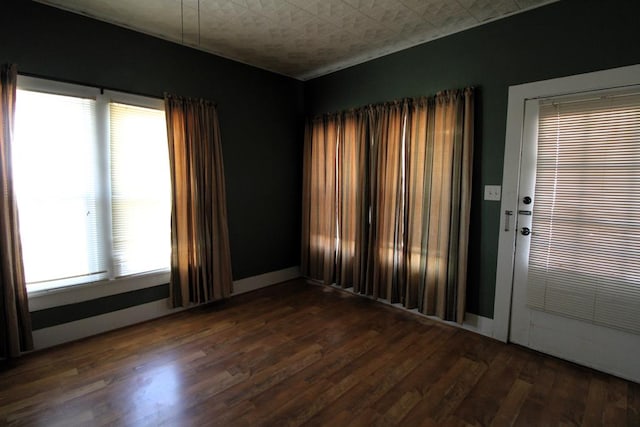 empty room with dark hardwood / wood-style floors