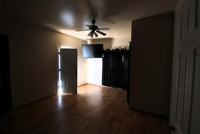 unfurnished room with ceiling fan and dark hardwood / wood-style flooring