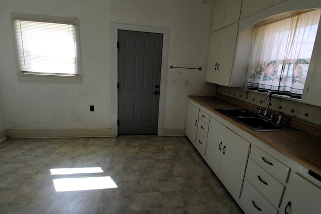 kitchen with white cabinetry and sink