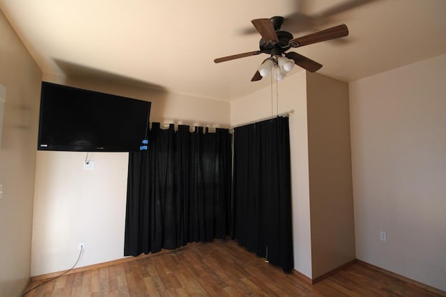 unfurnished room featuring ceiling fan and wood-type flooring