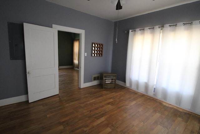 unfurnished room featuring dark hardwood / wood-style flooring, electric panel, and ceiling fan