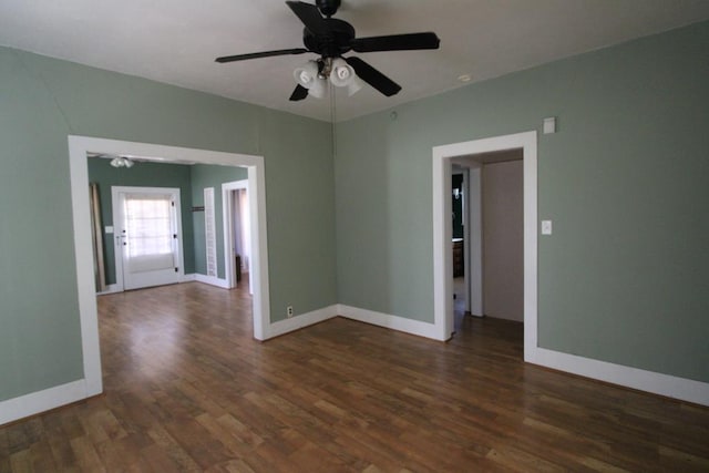 unfurnished room featuring ceiling fan and dark wood-type flooring