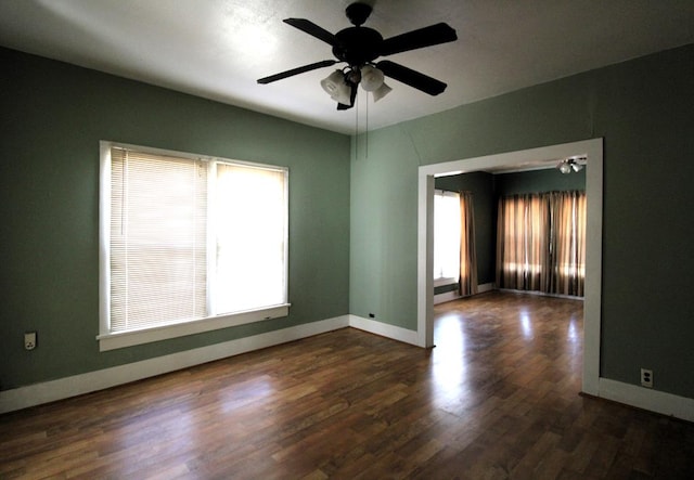 spare room featuring dark hardwood / wood-style floors and ceiling fan