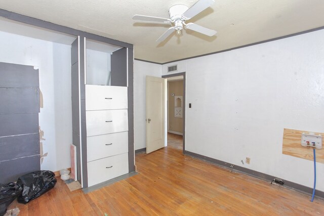 unfurnished bedroom with ceiling fan, light hardwood / wood-style flooring, and a textured ceiling