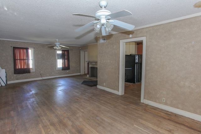 unfurnished living room featuring crown molding, ceiling fan, a textured ceiling, and hardwood / wood-style flooring