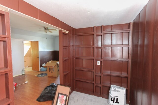 interior space with ceiling fan, light hardwood / wood-style flooring, and a textured ceiling