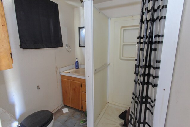 bathroom with a shower with shower curtain, vanity, and tile patterned flooring