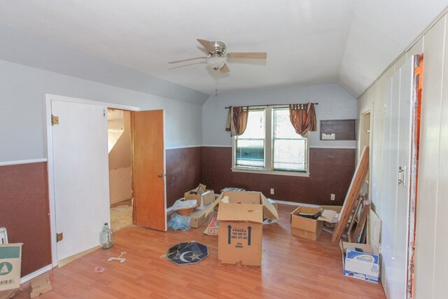 interior space featuring ceiling fan, light hardwood / wood-style floors, and lofted ceiling