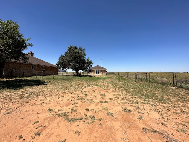 view of yard with a rural view