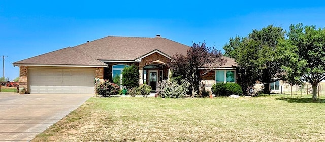 view of front of home featuring a front yard and a garage