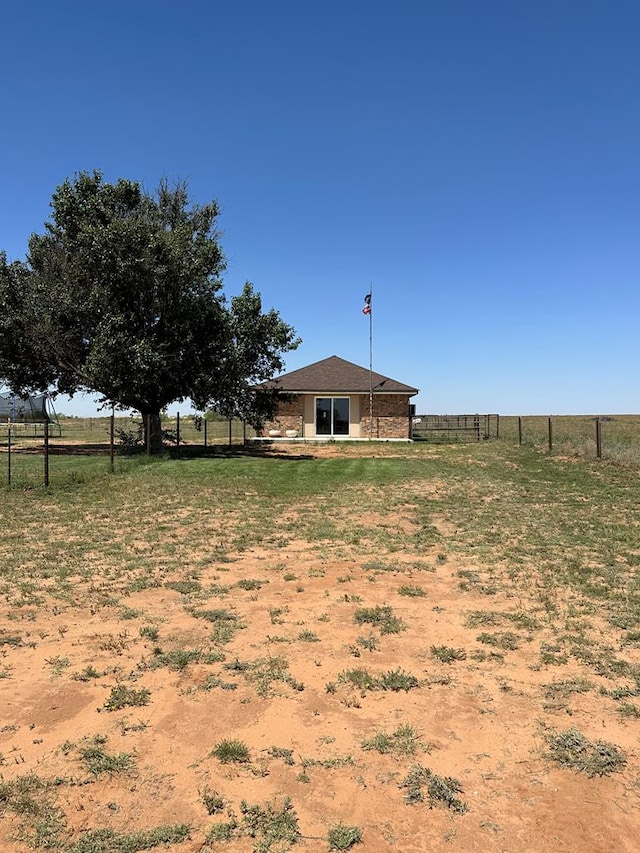 view of yard with a rural view