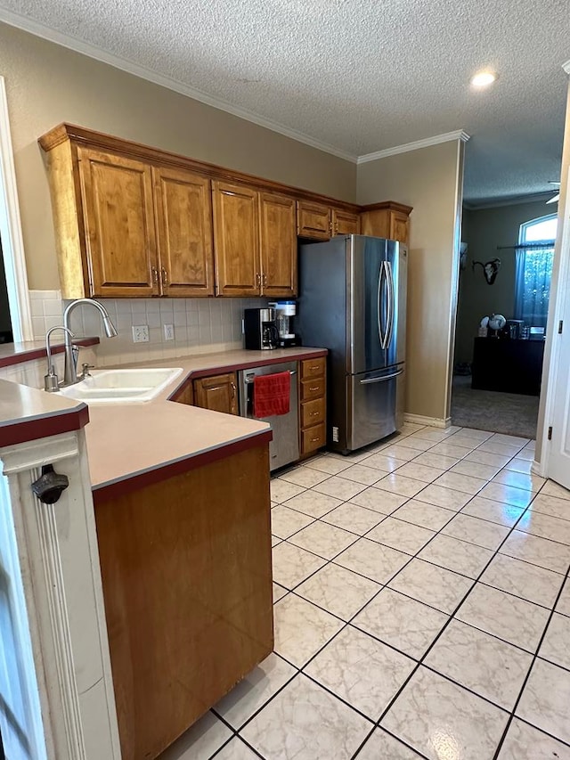 kitchen with light tile patterned floors, sink, and appliances with stainless steel finishes