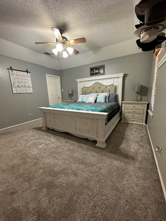 bedroom featuring carpet flooring, ceiling fan, and a textured ceiling