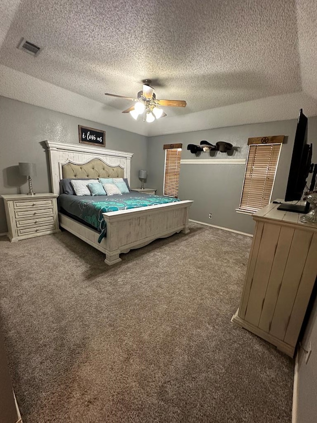 carpeted bedroom featuring a textured ceiling and ceiling fan