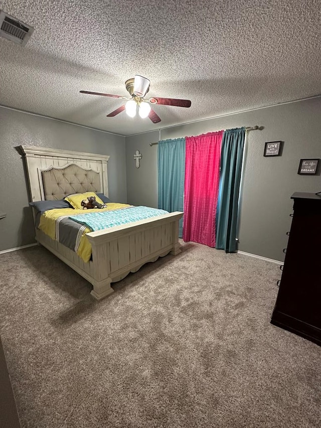 bedroom with carpet flooring, ceiling fan, and a textured ceiling