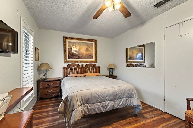 3013 Whittle Way, Midland, TX 79707 - bedroom with a textured ceiling, dark wood-style floors, and a ceiling fan