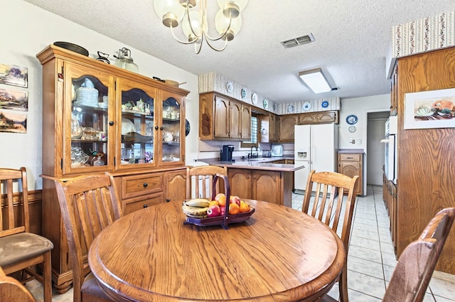 3013 Whittle Way, Midland, TX 79707 - dining room featuring a chandelier, a textured ceiling, and light tile patterned flooring