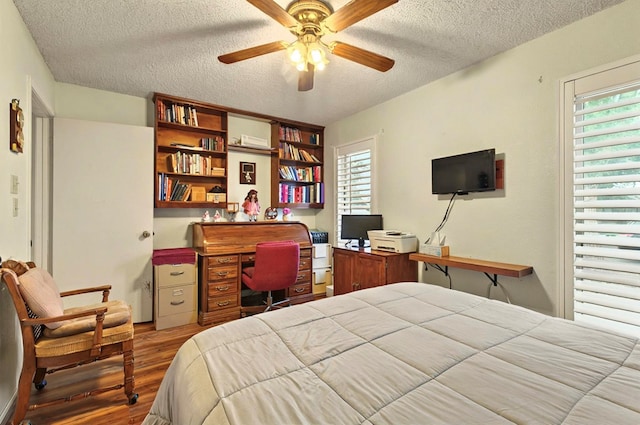 3013 Whittle Way, Midland, TX 79707 - bedroom featuring a textured ceiling, wood finished floors, and an office area