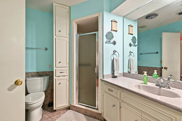 3013 Whittle Way, Midland, TX 79707 - bathroom featuring vanity, a shower stall, toilet, wainscoting, and tile patterned floors
