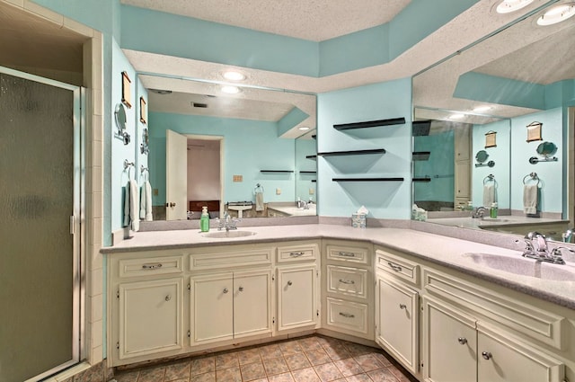 3013 Whittle Way, Midland, TX 79707 - bathroom with a shower stall, double vanity, and a textured ceiling