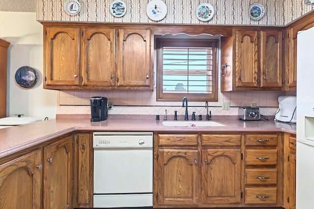 3013 Whittle Way, Midland, TX 79707 - kitchen featuring dishwasher, a sink, backsplash, and brown cabinets