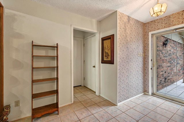 3013 Whittle Way, Midland, TX 79707 - unfurnished bedroom featuring light tile patterned floors, a textured ceiling, baseboards, and access to exterior