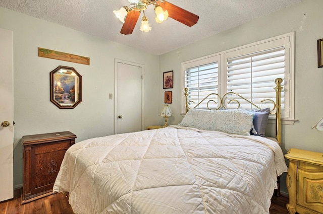 3013 Whittle Way, Midland, TX 79707 - bedroom featuring dark wood-type flooring, a textured ceiling, and ceiling fan