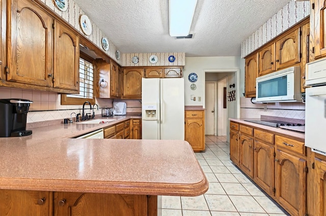 3013 Whittle Way, Midland, TX 79707 - kitchen with white appliances, a sink, brown cabinets, a textured ceiling, and tasteful backsplash