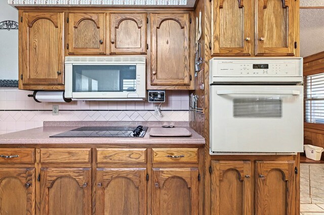 3013 Whittle Way, Midland, TX 79707 - kitchen featuring white appliances, brown cabinetry, and backsplash