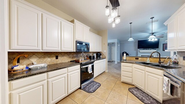 753 Shepherd Cir, Andrews, TX 79714 - kitchen featuring appliances with stainless steel finishes, tasteful backsplash, decorative light fixtures, and light tile patterned flooring