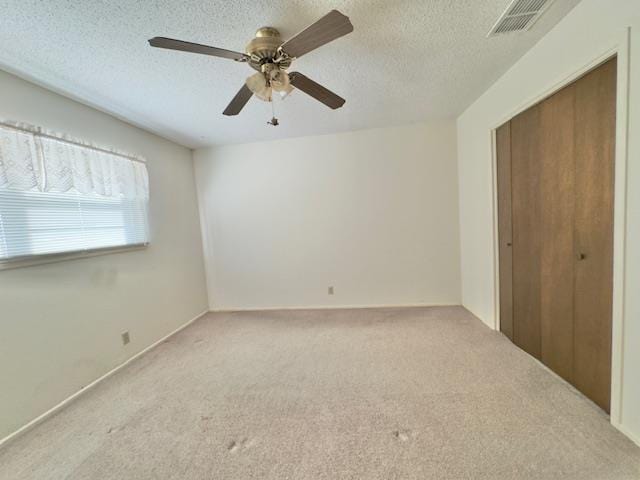2015 W 7th St, Fort Stockton, TX 79735 - unfurnished bedroom featuring carpet floors, a closet, a textured ceiling, and ceiling fan