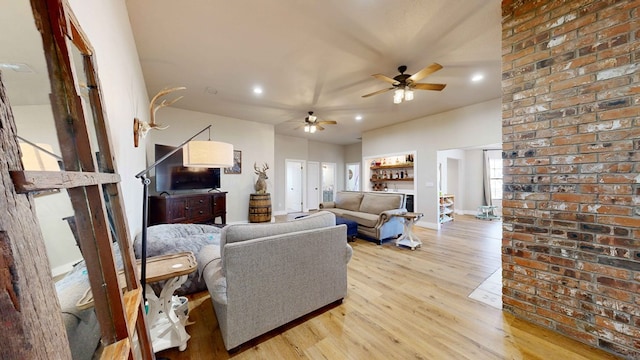 living room with light hardwood / wood-style floors and ceiling fan