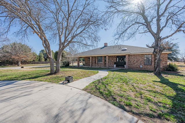 ranch-style home featuring a front yard